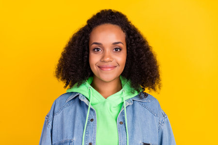 Photo of shiny pretty afro woman wear denim jacket smiling isolated yellow color background