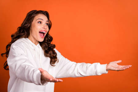 Photo portrait smiling woman amazed staring opened hands missing friends embracing isolated vivid...