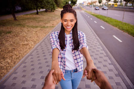 Photo of funny adorable girlfriend boyfriend wear casual outfits smiling walking holding palms outside urban city streetの写真素材