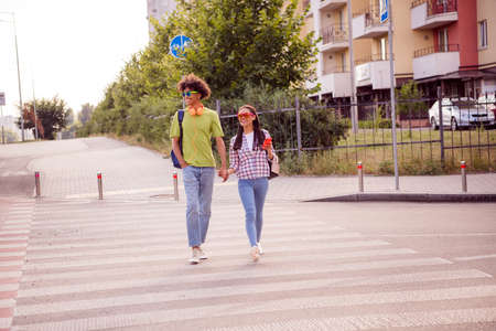 Portrait of attractive cheerful couple enjoying date good mood weekend going holding hands lifestyle outdoorsの写真素材