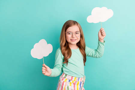 Photo of young girl happy positive smile weather forecast cloud stick isolated over teal color backgroundの写真素材
