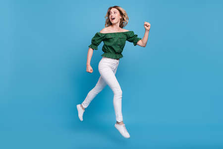 Profile photo of lady jump run look back empty space wear bear shoulders green blouse isolated blue...