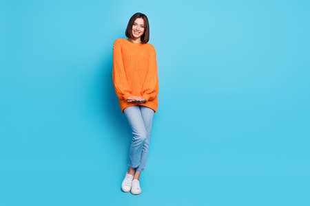 Full length body size view of attractive cheerful cute girl posing isolated over bright blue color backgroundの写真素材