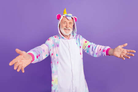 Photo of excited charming retired man nightwear overall want hug you smiling isolated purple color backgroundの写真素材