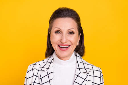 Portrait of satisfied glad astonished aged lady toothy smile look camera isolated on yellow color...