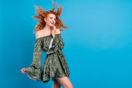 Photo of young lovely girl happy positive smile wind blow hair flirty isolated over blue color...