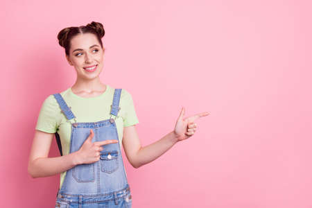 Photo of girl direct finger empty space look side wear sunglass jeans overall green t-shirt isolated...