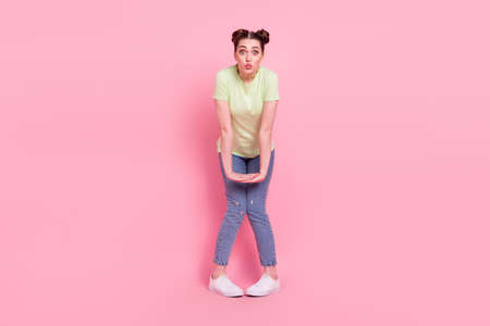 Photo of cute adorable affectionate girl shy send air kiss wear green t-shirt jeans sneakers...