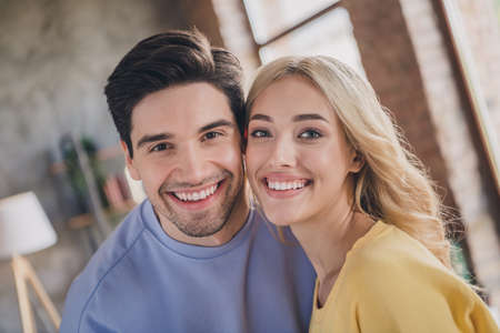 Portrait of attractive tender gentle cheerful couple spending free time weekend at home loft...