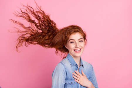 Photo of adorable pretty young lady dressed jeans shirt smiling arm chest isolated pink color backgroundの写真素材