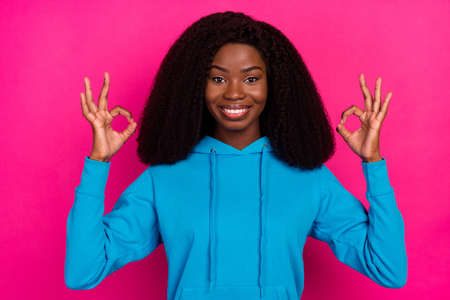 Photo portrait of woman showing okay gesture smiling isolated on vivid pink color background