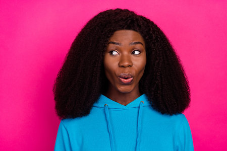 Photo of charming funny dark skin woman dressed blue sweatshirt smiling looking empty space isolated...