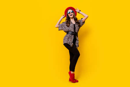 Full length photo of pretty nice stunning young woman wear cool sunglass glamour isolated on yellow color backgroundの写真素材