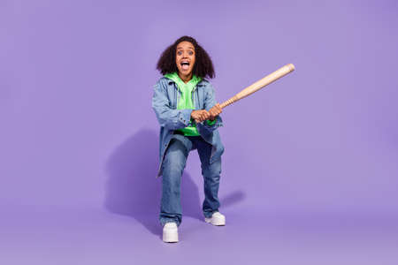 Full size photo of astonished crazy street thug attractive lady hold bat isolated on purple color backgroundの写真素材