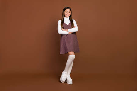 Full size photo of young pretty girl wear modern outfit uniform smart pupil isolated over brown color backgroundの写真素材
