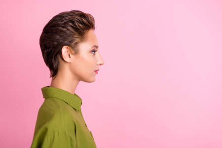 Profile photo of calm focused lady serious look empty space wear green shirt isolated pink color backgroundの写真素材