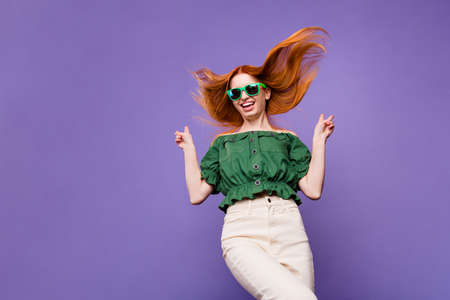 Photo of funny ginger young lady show v-sign wear eyewear green bare shoulders blouse isolated on violet backgroundの写真素材