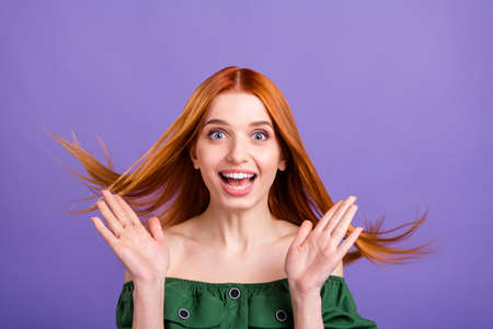 Photo of young attractive girl happy positive smile amazed surprised news sale isolated over violet color backgroundの写真素材