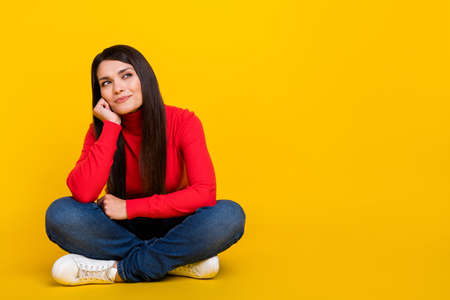 Full size portrait of pretty positive lady arm on cheek look interested empty space isolated on yellow color backgroundの写真素材