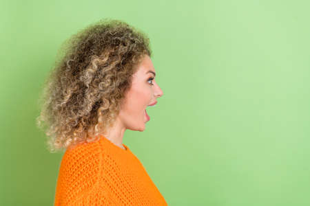 Profile photo of cool millennial blond lady look suggest wear orange sweater isolated on green color backgroundの写真素材