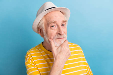 Portrait of attractive minded man touching chin creating strategy idea solution isolated over bright...