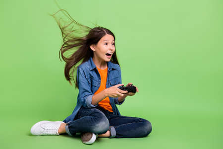 Full body profile photo of hooray preteen girl play station yell look promo wear shirt jeans...