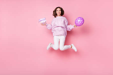 Full length body size view of pretty slim cheerful girl jumping holding giftbox air ball Eve Noel...