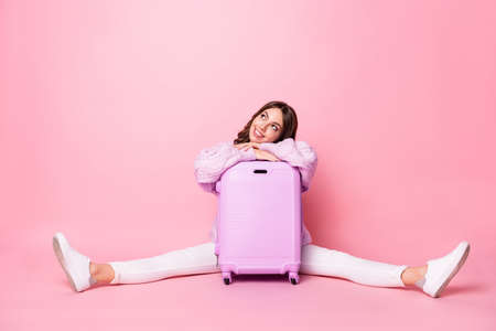 Full length portrait of cheerful lady put hands on bag look interested empty space isolated on pink color backgroundの写真素材