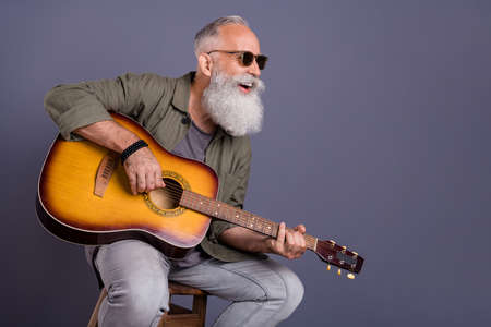 Photo of retired man eyewear bar guitarist performance curious look empty space isolated over grey...
