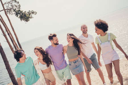 Photo of adorable funny six young buddies dressed casual outfits walking embracing smiling outdoors countrysideの写真素材