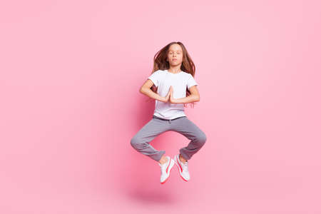 Full length body size view of attractive dreamy girl jumping meditating calm time isolated over pink...