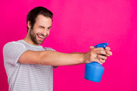 Profile photo of crazy funny playful childish guy aim pulverizer shot wear grey t-shirt isolated pink color backgroundの写真素材