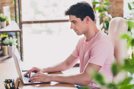 Photo of confident focused business man prepare remote project wear casual outfit in comfortable apartment home indoorsの写真素材