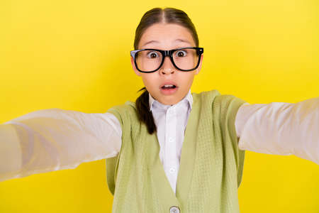Self-portrait of attractive amazed worried brown-haired girl sudden news reaction isolated over...