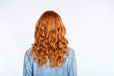 Rare view photo of woman with red curly hair wearing casual jeans jacket isolated on white color backgroundの写真素材