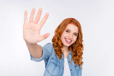 Photo of attractive young happy pretty woman hold hand give you high five isolated on grey color backgroundの写真素材