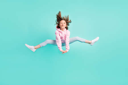 Full size photo of brunette hairdo funky girl jump wear pink sportswear isolated on teal color backgroundの写真素材