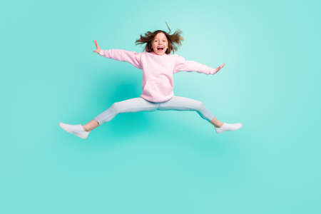 Full body photo of brunette hairdo hooray girl jump wear pink sportswear isolated on teal color backgroundの写真素材