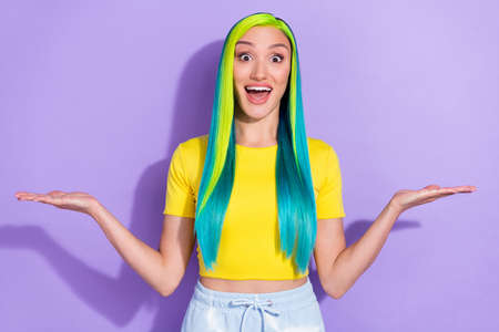 Portrait of beautiful amazed girl advertise product compare products vs scales isolated on violet...