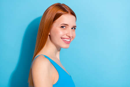 Photo portrait red haired woman wearing pretty singlet smiling happy isolated pastel blue color background copyspaceの写真素材