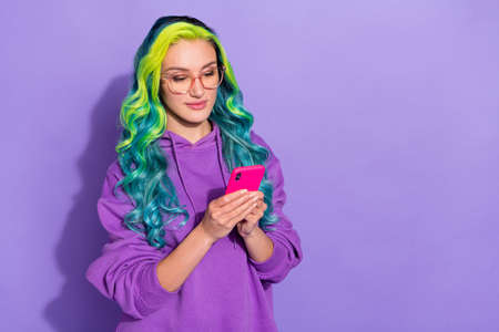 Photo of millennial lady with vibrant haircut use app blog smart phone like post isolated over purple color backgroundの写真素材