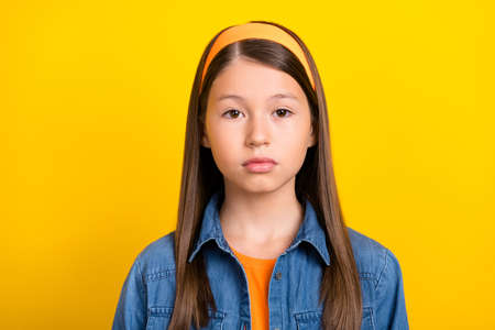 Photo of serious confident student girl wear denim shirt retro headband isolated yellow color...