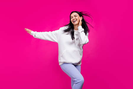 Photo of positive dream funky lady dance touch tender cheek wear white sweatshirt isolated pink color backgroundの写真素材
