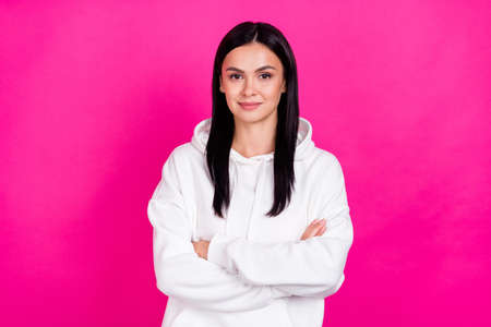 Photo of self-assured lady folded hands look camera wear white sweatshirt hoodie isolated pink color...