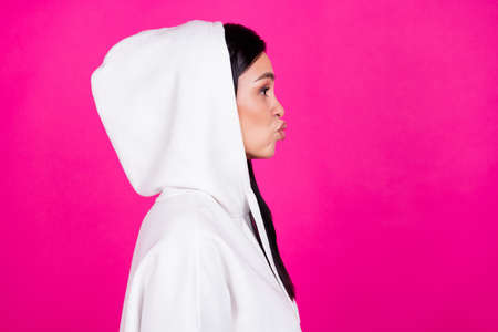 Profile side photo of young lady pouted lips flirty look empty space isolated over magenta color backgroundの写真素材