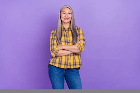 Photo of charming lovely woman crossed hands wear casual clothes isolated over violet color backgroundの写真素材