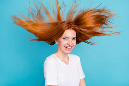 Photo of young attractive girl happy positive smile air fly wind blow beauty spa therapy gisolated over blue color backgroundの写真素材