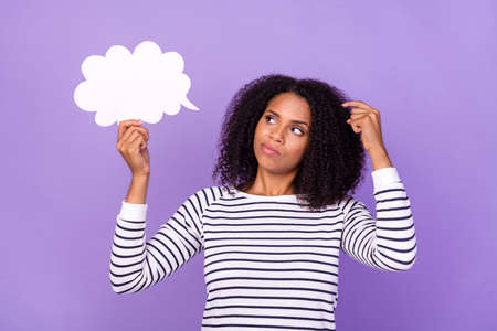 Photo of serious thoughtful smart woman hold speech bubble scratch head thinking isolated on purple color backgroundの写真素材