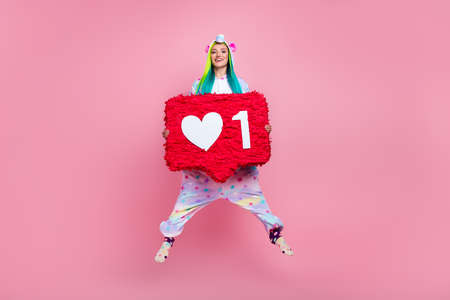 Full length body size view of attractive cheery girl in kigurumi jumping holding like isolated on...