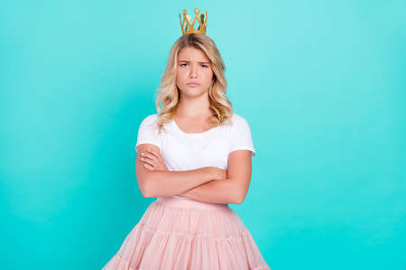Photo of grumpy offended princess lady crossed hands wear crown white t-shirt isolated aquamarine color backgroundの写真素材